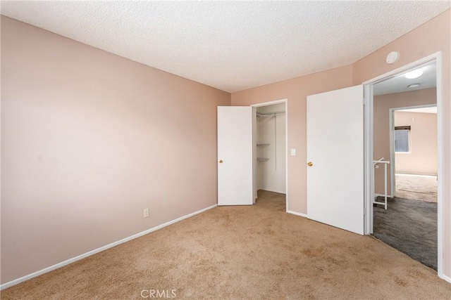 1076 N Ironwood Ave, Rialto, CA 92376 - unfurnished bedroom featuring baseboards, a closet, carpet, and a textured ceiling