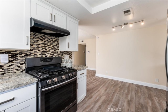 1076 N Ironwood Ave, Rialto, CA 92376 - kitchen with white cabinets, stainless steel range with gas cooktop, under cabinet range hood, and decorative backsplash