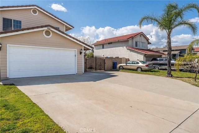1076 N Ironwood Ave, Rialto, CA 92376 - exterior space with a tiled roof, a gate, a garage, and concrete driveway