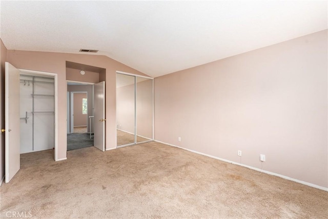 1076 N Ironwood Ave, Rialto, CA 92376 - unfurnished bedroom featuring vaulted ceiling, carpet, multiple closets, and visible vents