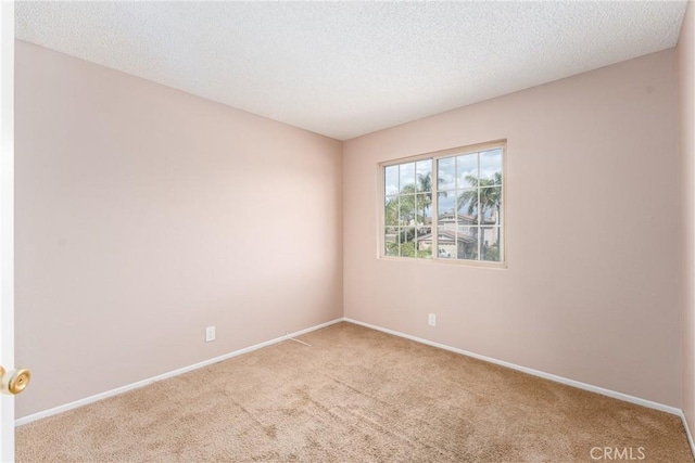 1076 N Ironwood Ave, Rialto, CA 92376 - empty room featuring baseboards, a textured ceiling, and carpet