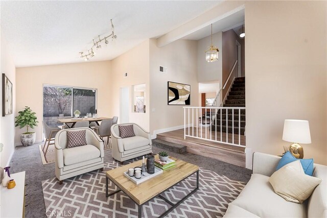 1076 N Ironwood Ave, Rialto, CA 92376 - living area featuring stairway, lofted ceiling, baseboards, a chandelier, and carpet floors