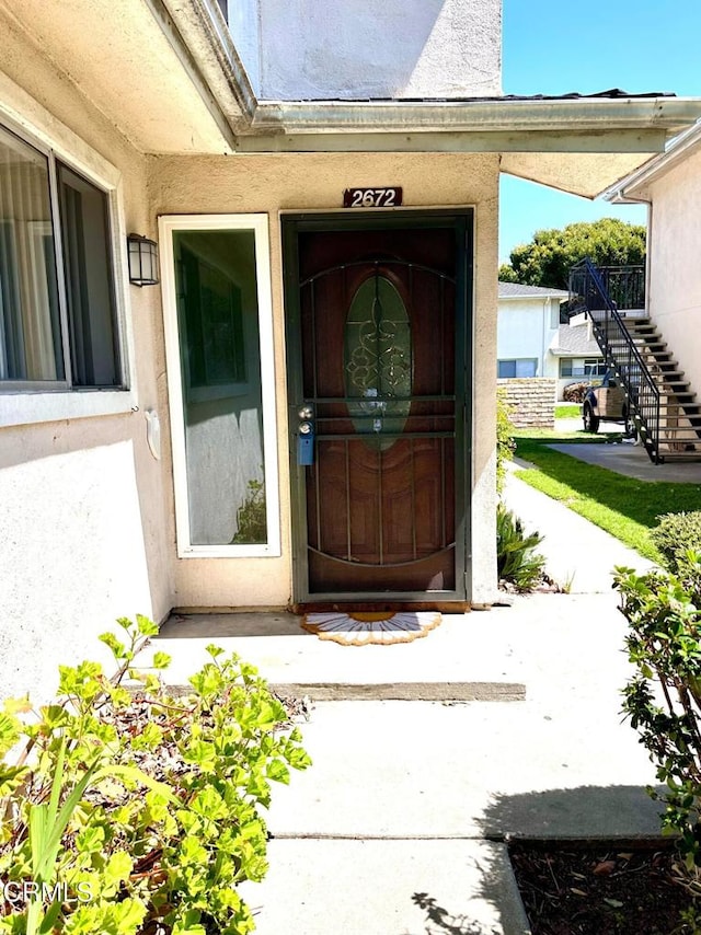 doorway to property with stucco siding