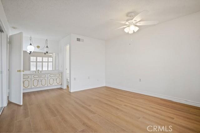 19324 Flowers Ct, Newhall, CA 91321 - empty room with light wood-style floors, a ceiling fan, and baseboards