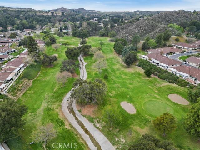 bird's eye view featuring golf course view, a mountain view, and a residential view