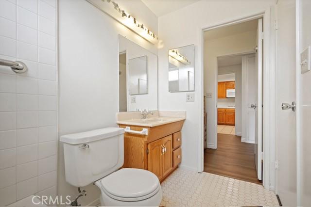19324 Flowers Ct, Newhall, CA 91321 - bathroom featuring vanity, toilet, and tile patterned flooring