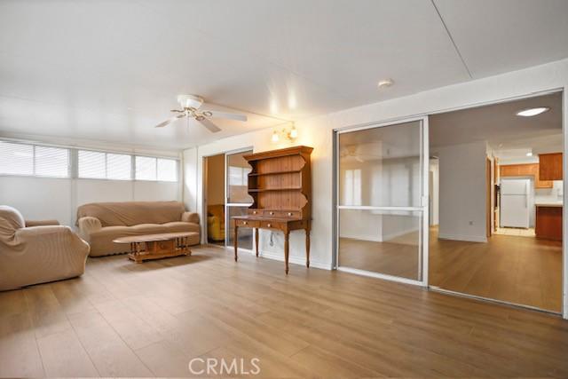 19324 Flowers Ct, Newhall, CA 91321 - living room featuring wood finished floors, a ceiling fan, and baseboards