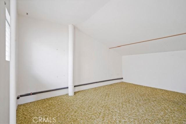 bonus room featuring lofted ceiling and carpet