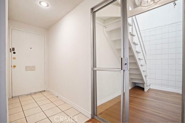 19324 Flowers Ct, Newhall, CA 91321 - doorway to outside with baseboards and light wood finished floors