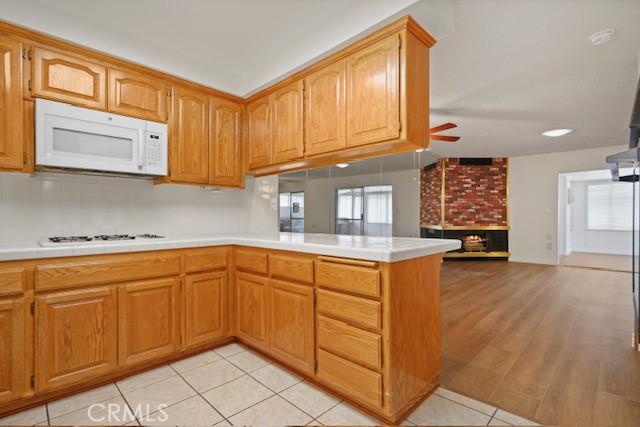 19324 Flowers Ct, Newhall, CA 91321 - kitchen with white appliances, ceiling fan, light countertops, and a peninsula