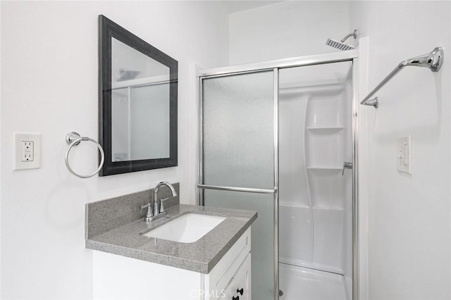 full bathroom with a stall shower and vanity