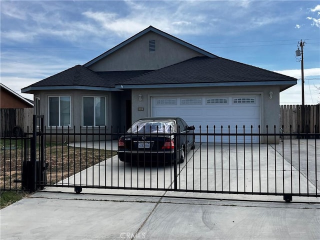 view of front of property with driveway, stucco siding, an attached garage, fence, and a shingled roof