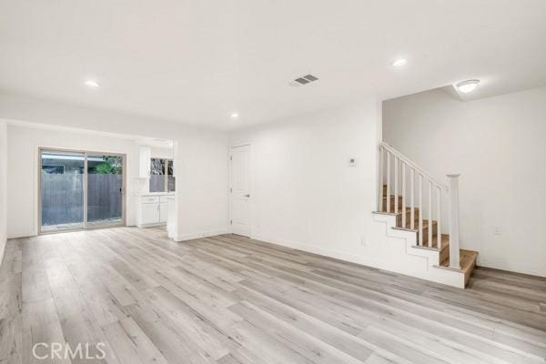 914 Fairview Ave Unit 15, Arcadia, CA 91007 - unfurnished living room with light wood-style flooring, recessed lighting, and stairs