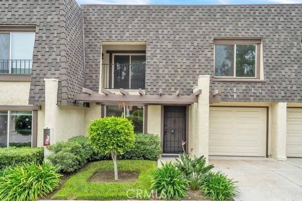 914 Fairview Ave Unit 15, Arcadia, CA 91007 - view of front property with concrete driveway, stucco siding, a shingled roof, and a garage