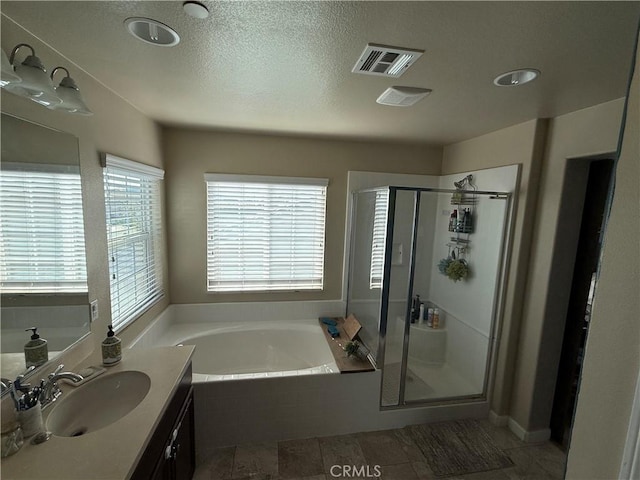 30130 Pine Needle Rd, Menifee, CA 92585 - bathroom featuring a bath, a stall shower, vanity, and a textured ceiling