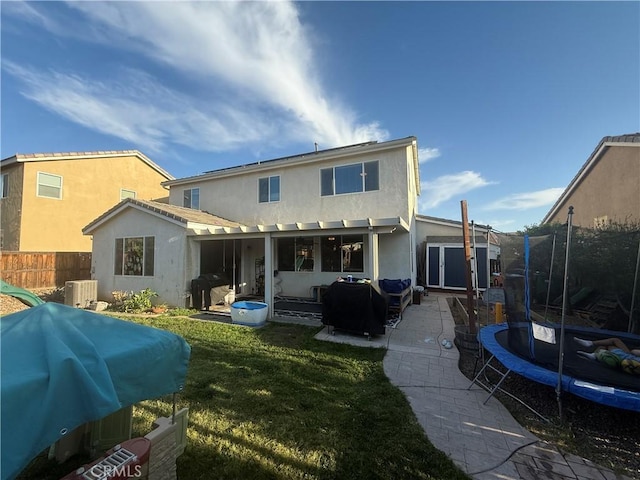 30130 Pine Needle Rd, Menifee, CA 92585 - rear view of house with a trampoline, a patio, and stucco siding