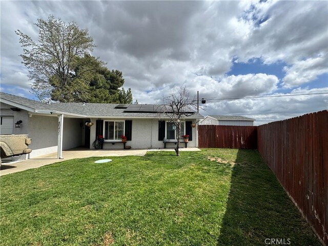 40451 Rome Beauty Way, Cherry Valley, CA 92223 - rear view of property featuring solar panels, stucco siding, and a shingled roof