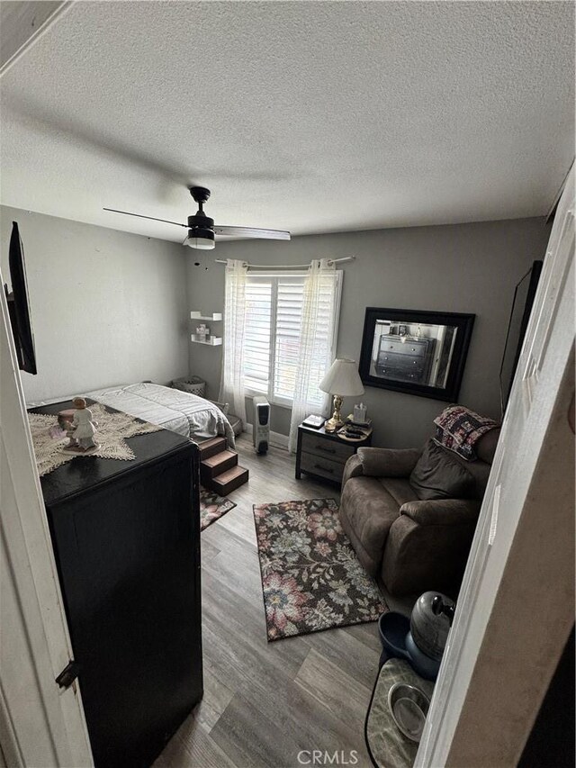 40451 Rome Beauty Way, Cherry Valley, CA 92223 - bedroom featuring a textured ceiling, wood finished floors, and a ceiling fan