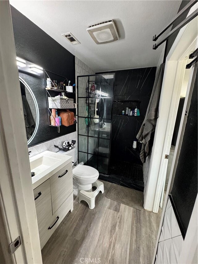 40451 Rome Beauty Way, Cherry Valley, CA 92223 - bathroom with tile walls, vanity, a shower stall, toilet, and wood finished floors