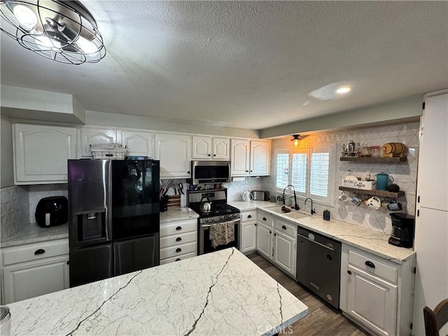 40451 Rome Beauty Way, Cherry Valley, CA 92223 - kitchen with appliances with stainless steel finishes, a sink, dark wood-style flooring, light stone counters, and backsplash