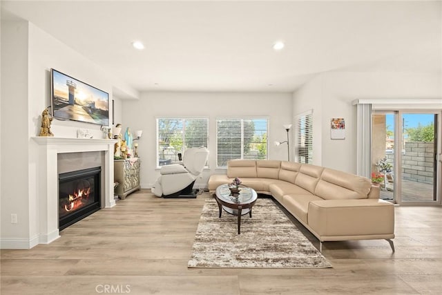 5402 Peck Rd, El Monte, CA 91732 - living room with recessed lighting, a glass covered fireplace, and light wood-style floors