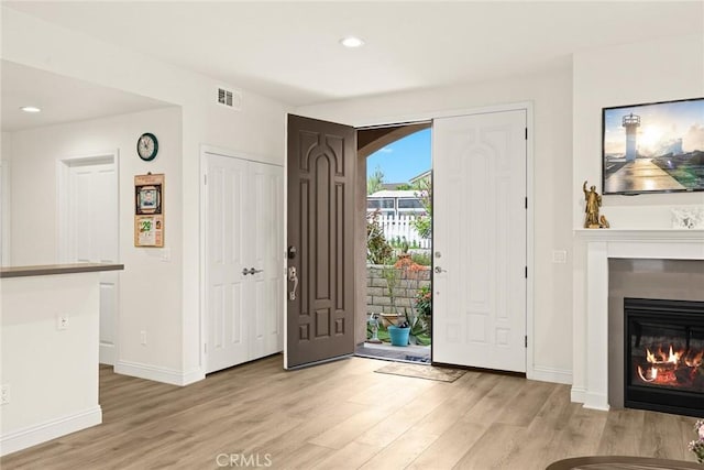 5402 Peck Rd, El Monte, CA 91732 - entrance foyer with light wood-style flooring, recessed lighting, and a glass covered fireplace