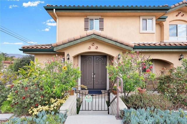 5402 Peck Rd, El Monte, CA 91732 - view of exterior entry featuring a tile roof, stucco siding, and a gate