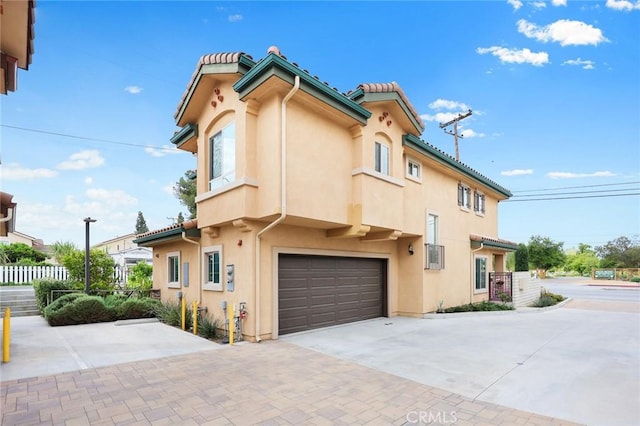 5402 Peck Rd, El Monte, CA 91732 - view of front facade featuring concrete driveway, an attached garage, stucco siding, and a tile roof