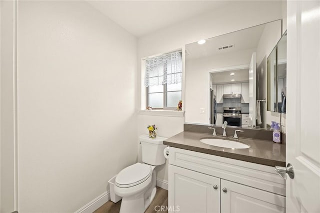5402 Peck Rd, El Monte, CA 91732 - bathroom with vanity, wood finished floors, and backsplash