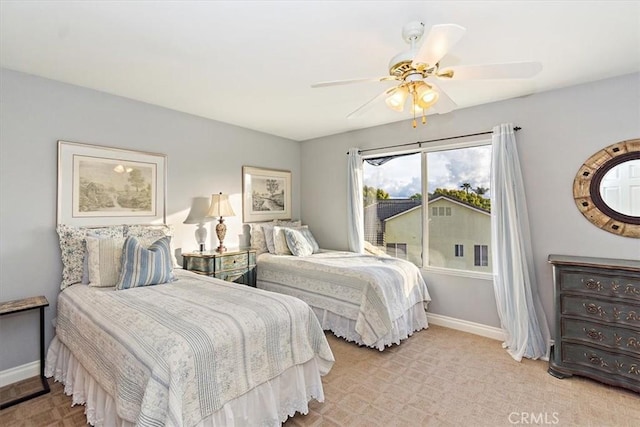 bedroom featuring baseboards, ceiling fan, and light carpet
