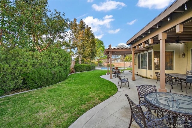 view of yard with a pergola, outdoor dining space, a patio area, and a ceiling fan