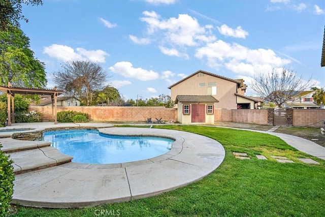 view of swimming pool with a storage unit, an outbuilding, a gate, and a pool with connected hot tub