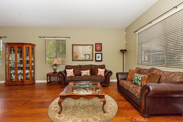 living area with wood finished floors and baseboards