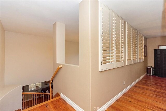 stairs with baseboards and wood finished floors
