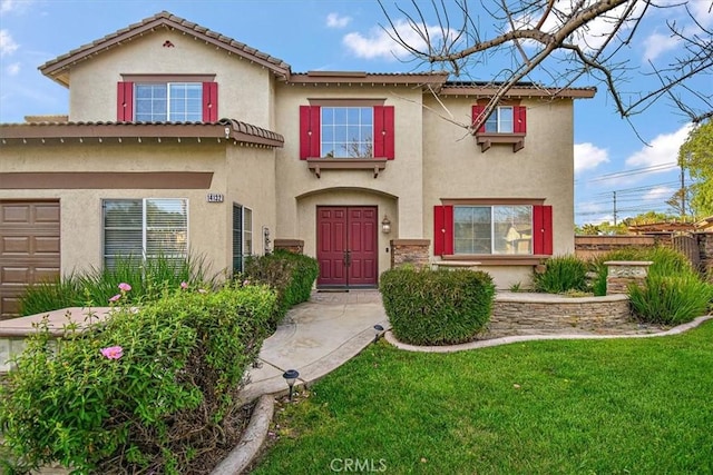 mediterranean / spanish-style house with stucco siding and a front lawn