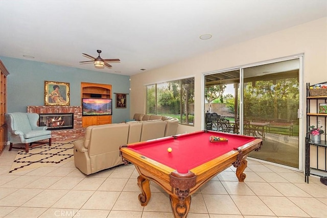 recreation room featuring a ceiling fan, light tile patterned flooring, billiards, and a fireplace