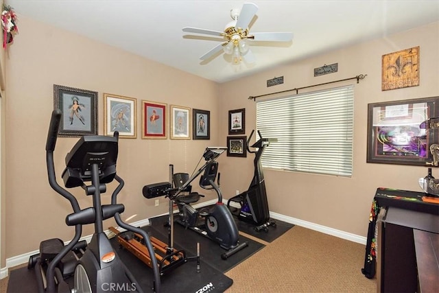 workout area featuring ceiling fan and baseboards
