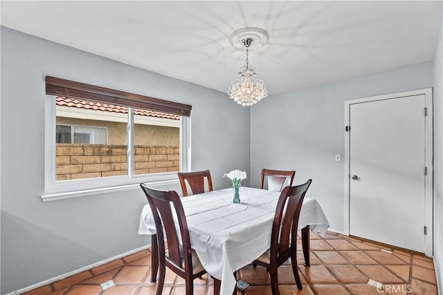 dining room with baseboards, light tile patterned flooring, and a chandelier