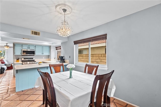 dining space with visible vents and ceiling fan with notable chandelier