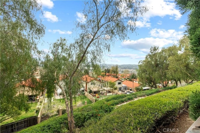 view of property's community with fence and a residential view
