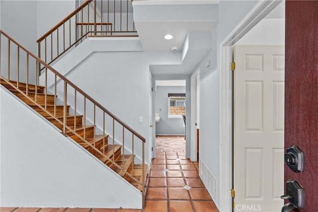 tiled entrance foyer with stairs