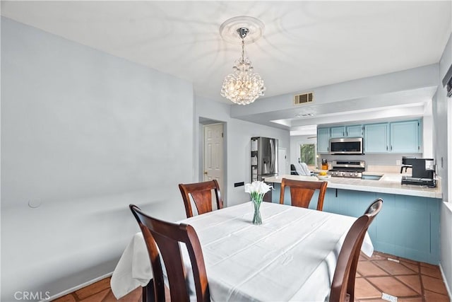 dining area with a chandelier and visible vents
