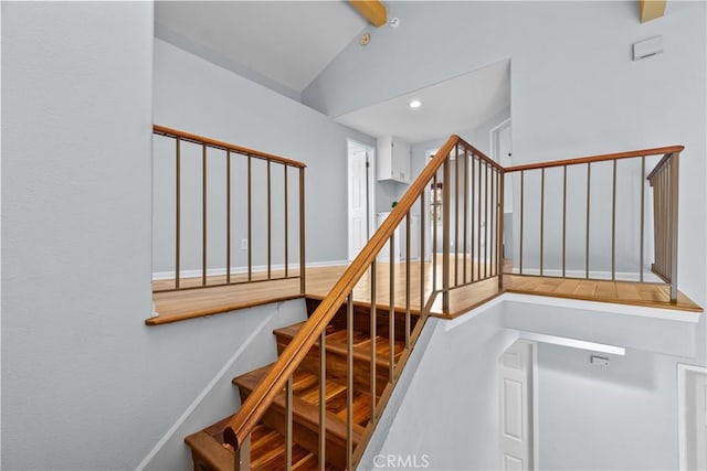 stairs with recessed lighting and lofted ceiling with beams