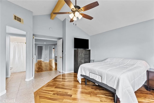 bedroom featuring visible vents, light tile patterned floors, beam ceiling, baseboards, and high vaulted ceiling