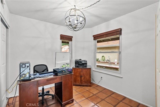office space featuring a wealth of natural light and a notable chandelier