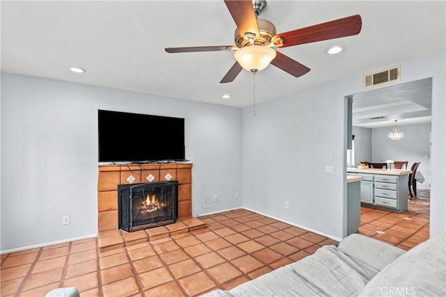 unfurnished living room with ceiling fan, recessed lighting, visible vents, and a fireplace