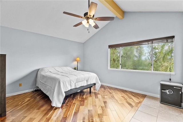 bedroom with ceiling fan, light wood-type flooring, baseboards, and lofted ceiling with beams
