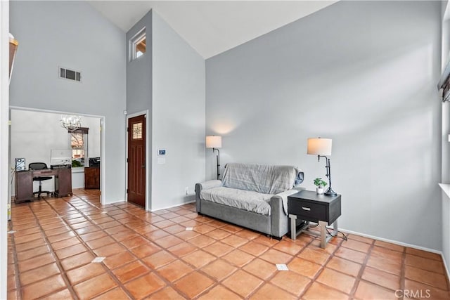 living area featuring baseboards, visible vents, a chandelier, high vaulted ceiling, and light tile patterned floors
