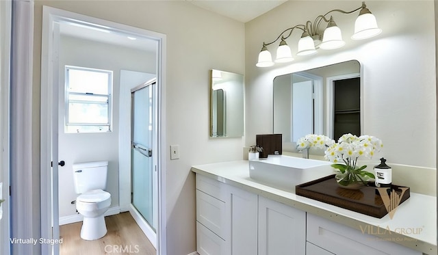 45299 Esmerado Ct, Temecula, CA 92592 - bathroom with wood finished floors, vanity, toilet, a shower stall, and baseboards