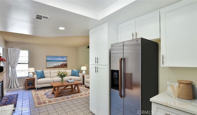 45299 Esmerado Ct, Temecula, CA 92592 - kitchen featuring stainless steel fridge, light tile patterned floors, white cabinetry, recessed lighting, and light countertops